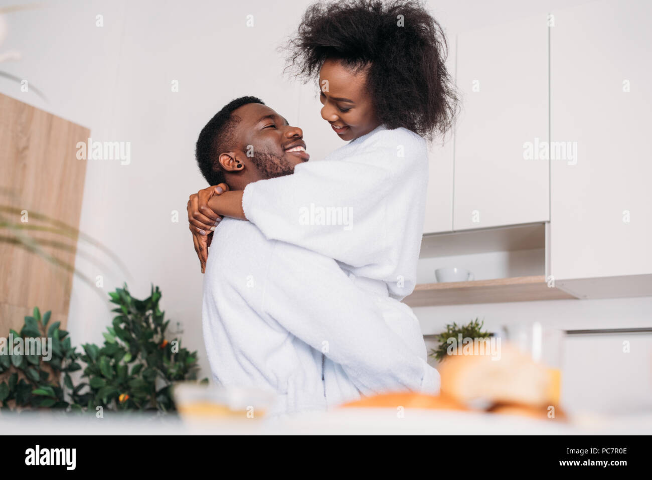 Low angle view of smiling african american couple in kitchen Stock Photo