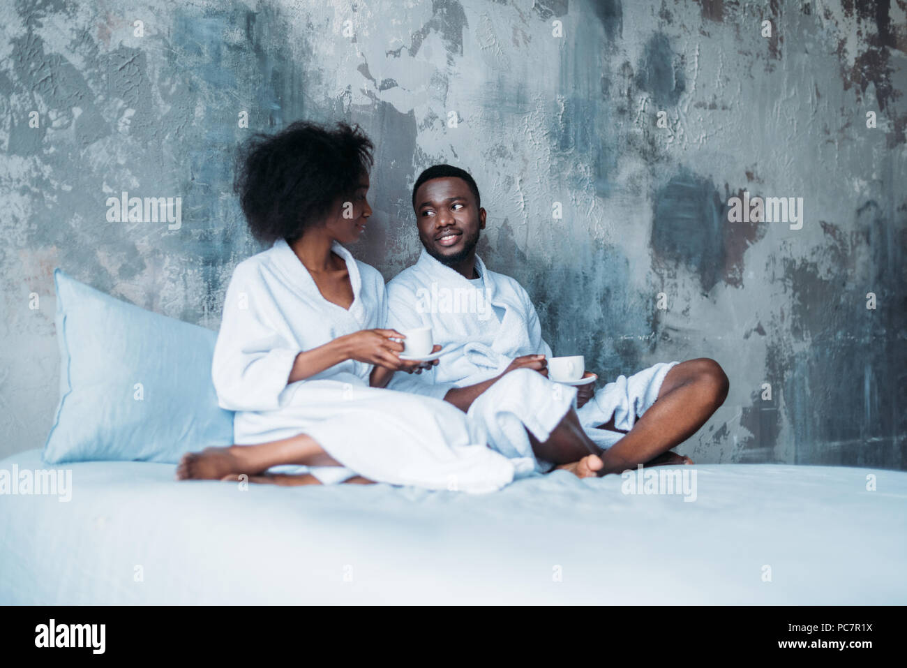 African american couple sitting in bed with cups of coffee Stock Photo ...