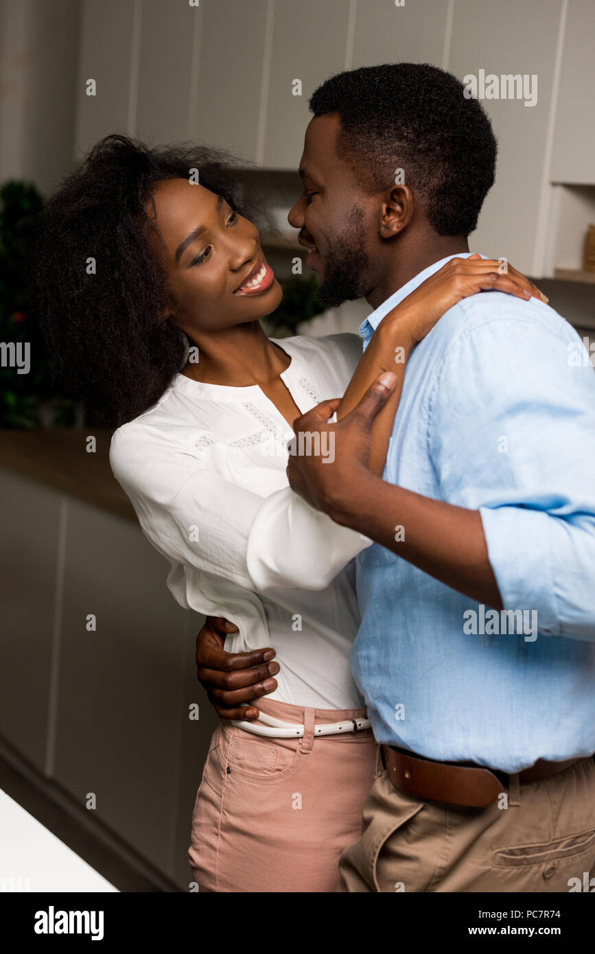 Young smiling african american couple dancing in kitchen Stock Photo ...