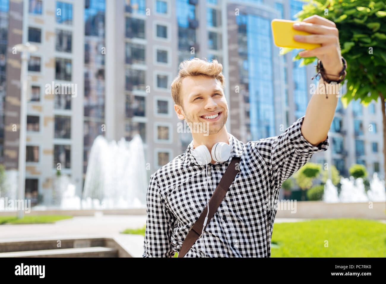 Delighted positive man taking a selfie Stock Photo