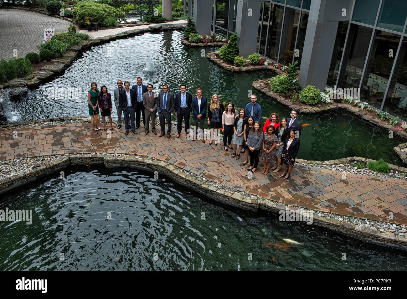 UNITED STATES: July 31, 2018: People that attended the Next Gen luncheon at the 2941 Restaurant in Arlington Virginia pose for a photo at the koi fish Stock Photo