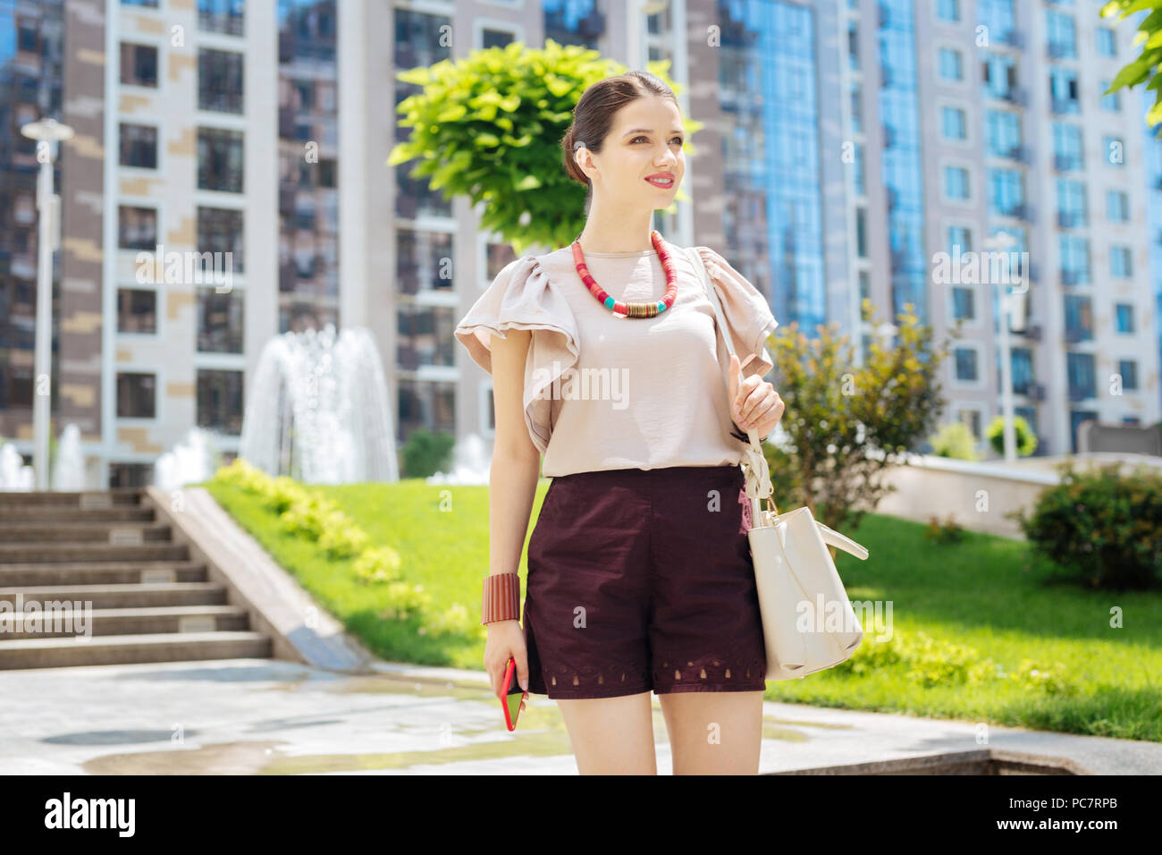 Delighted young woman having a walk Stock Photo