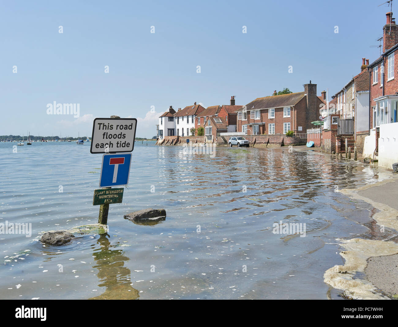 Bosham Harbour flooding at high tide on a sunny summer day Stock Photo -  Alamy