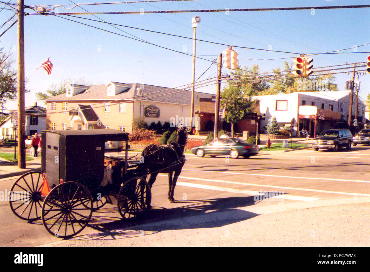 ca. 2005 - A horse-drawn carriage in Berlin, OH waits at a stoplight for its turn to proceed. Stock Photo