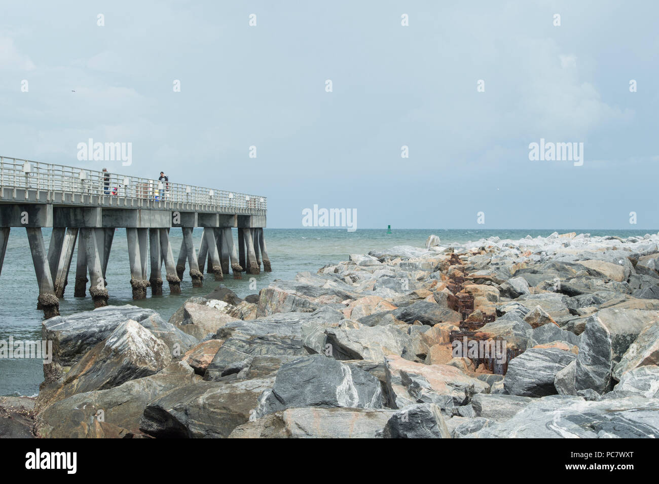 The fishing pier that parallels the jetty on Cocoa Beach in Florida