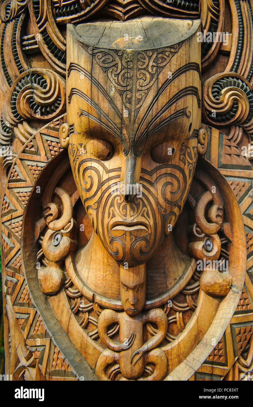 Traditional wood carved mask in the Te Puia Maori Cultural Center, Roturura, North Island, New Zealand Stock Photo