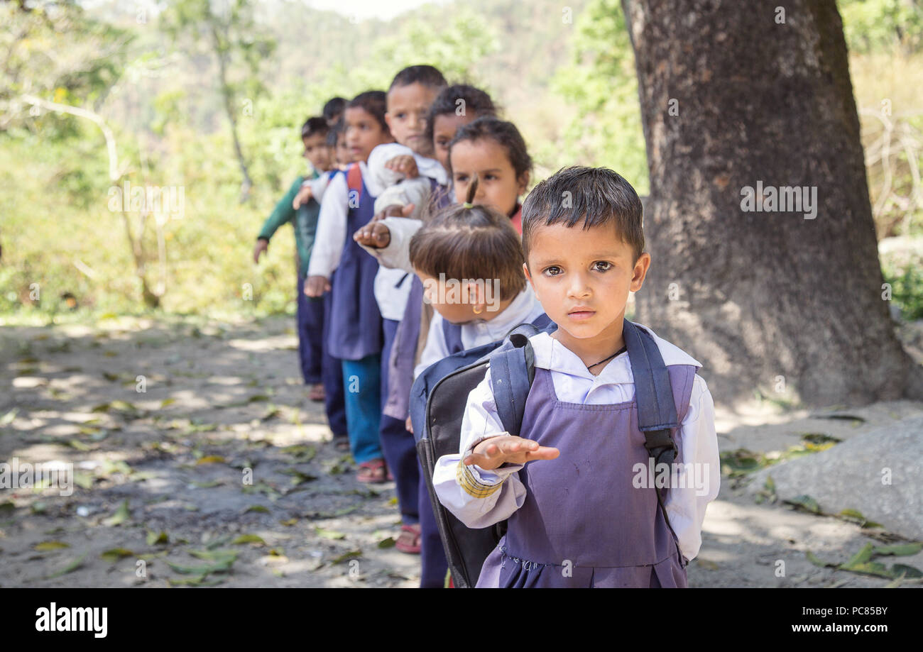 Village elementary school kids forming line for morning prayer. different age group children wearing school uniform. Stock Photo