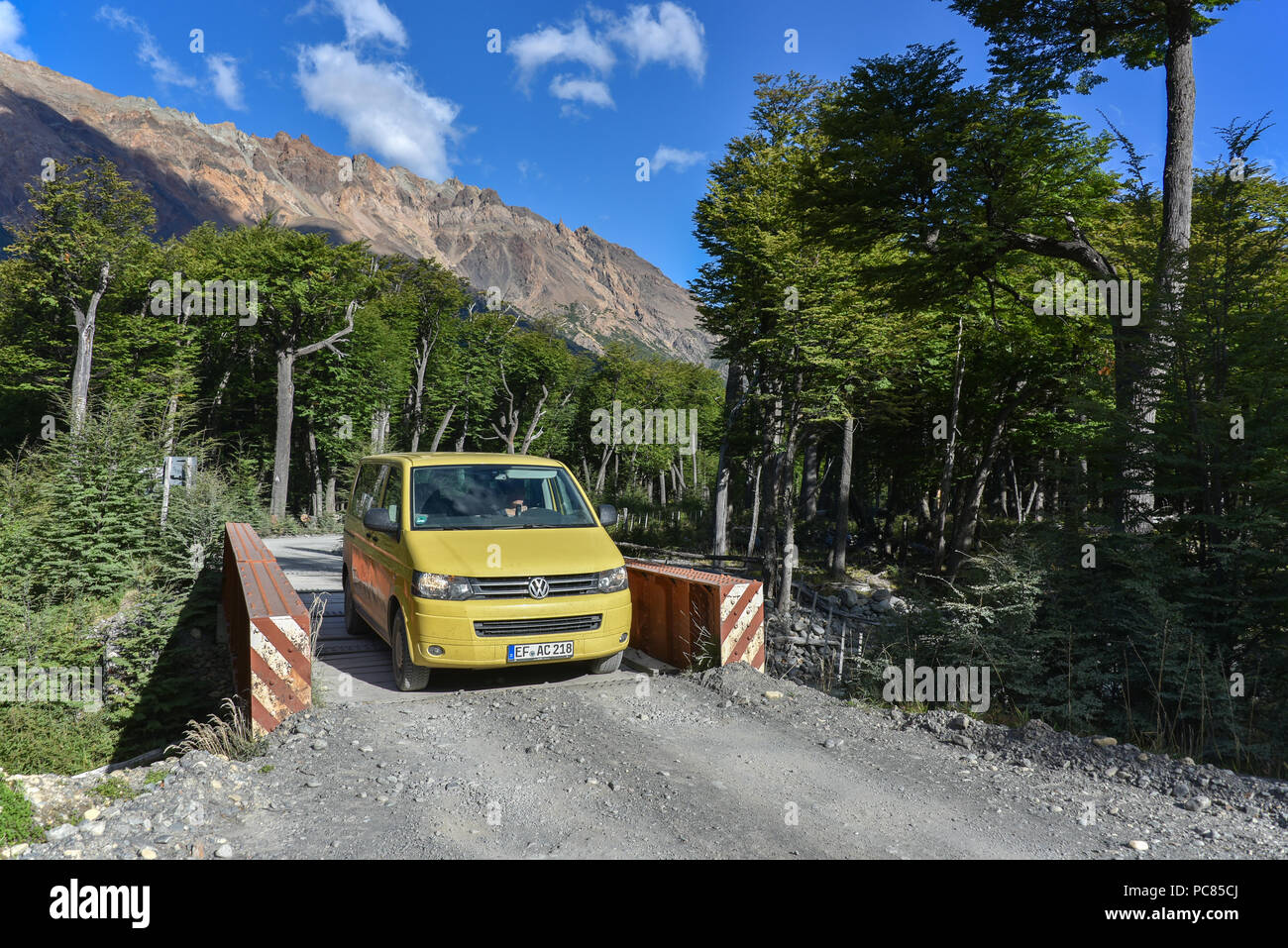 Yellow travel minibus on road to Lago del Desierto at Rio de las Vueltas, near El Chalten, Patagonia, Argentina, South America Stock Photo
