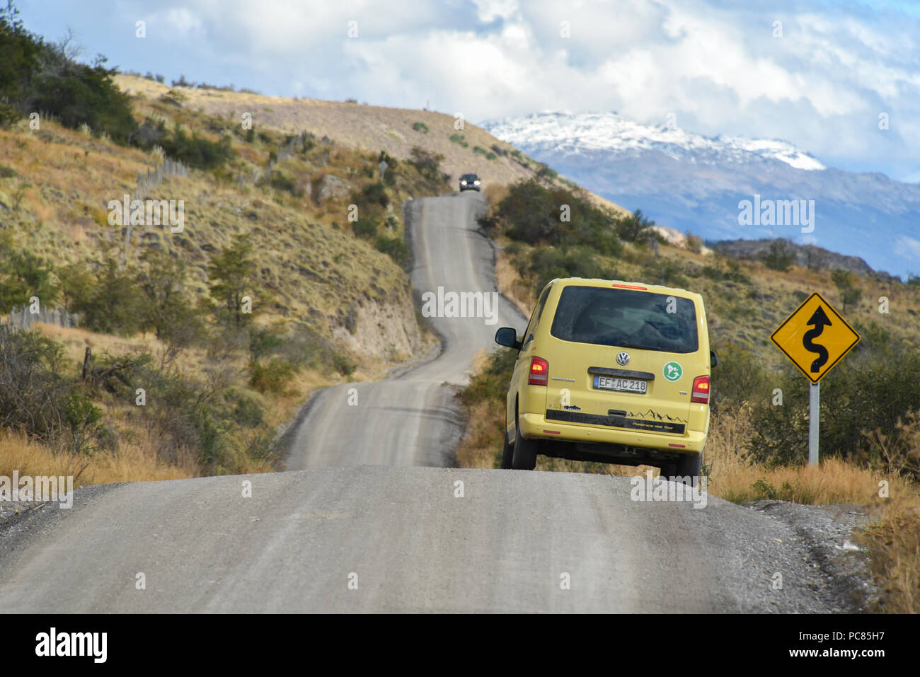 Yellow travel minibus on the Carretera Austral at Cochrane at road sign, Patagonia, Chile, South America Stock Photo