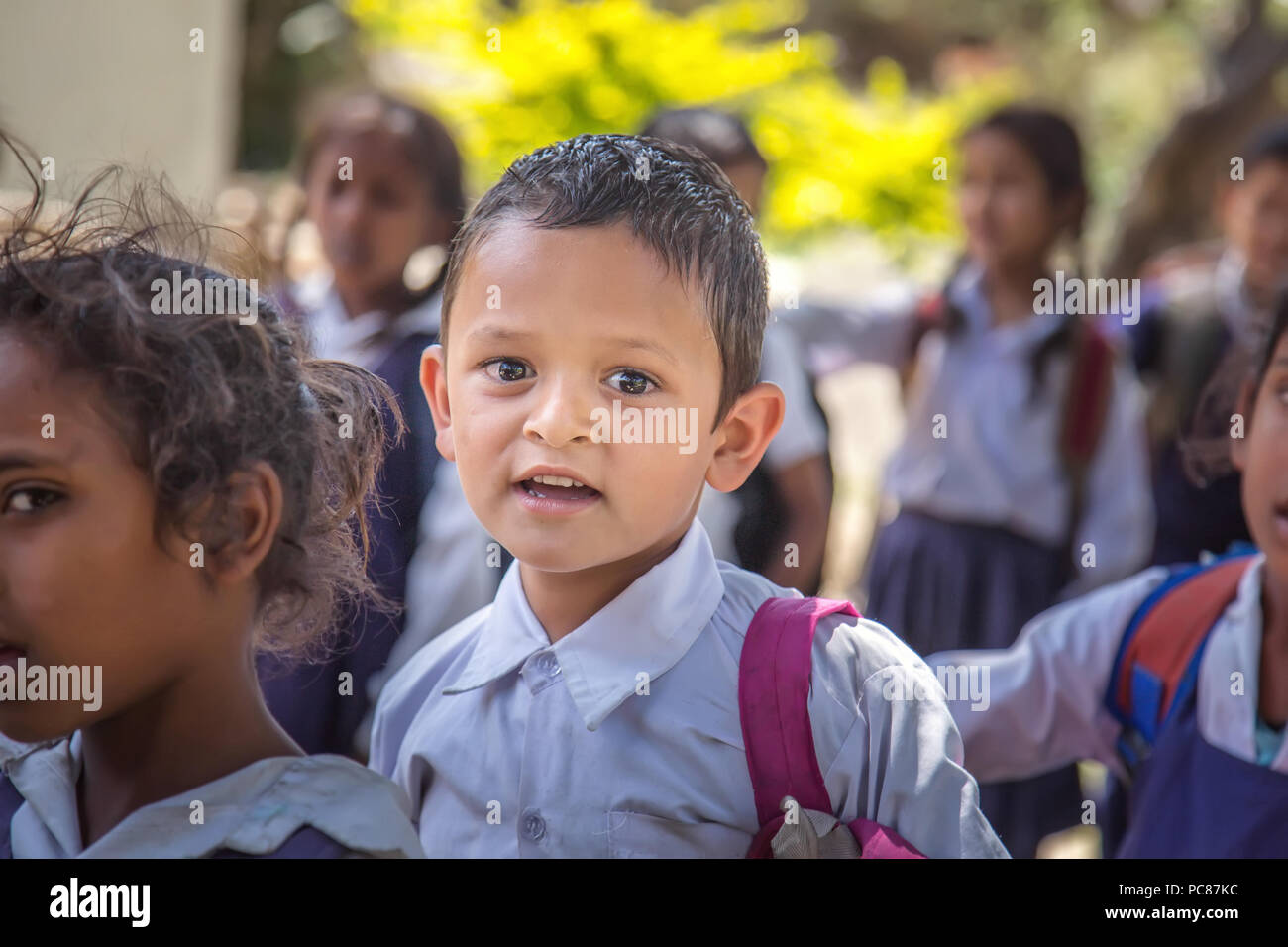 Happy little preschooler boy Wearing school uniform standing during morning assembly. Stock Photo