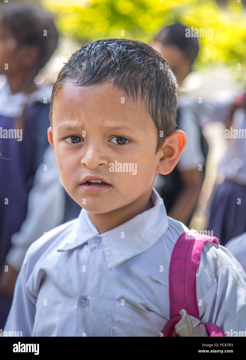Happy little preschooler boy Wearing school uniform standing during morning assembly. Stock Photo