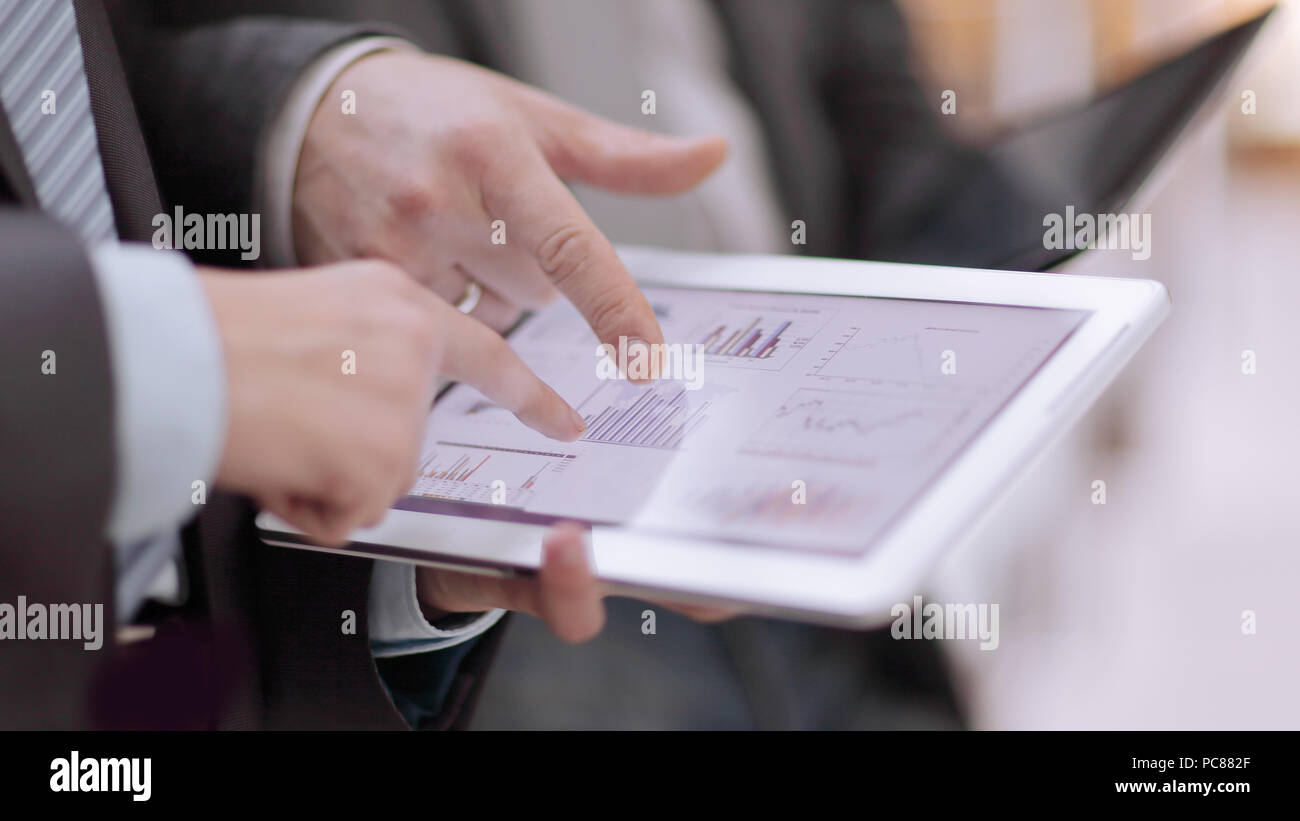 close up.businessmens discuss schedule of sales through the tablet ...