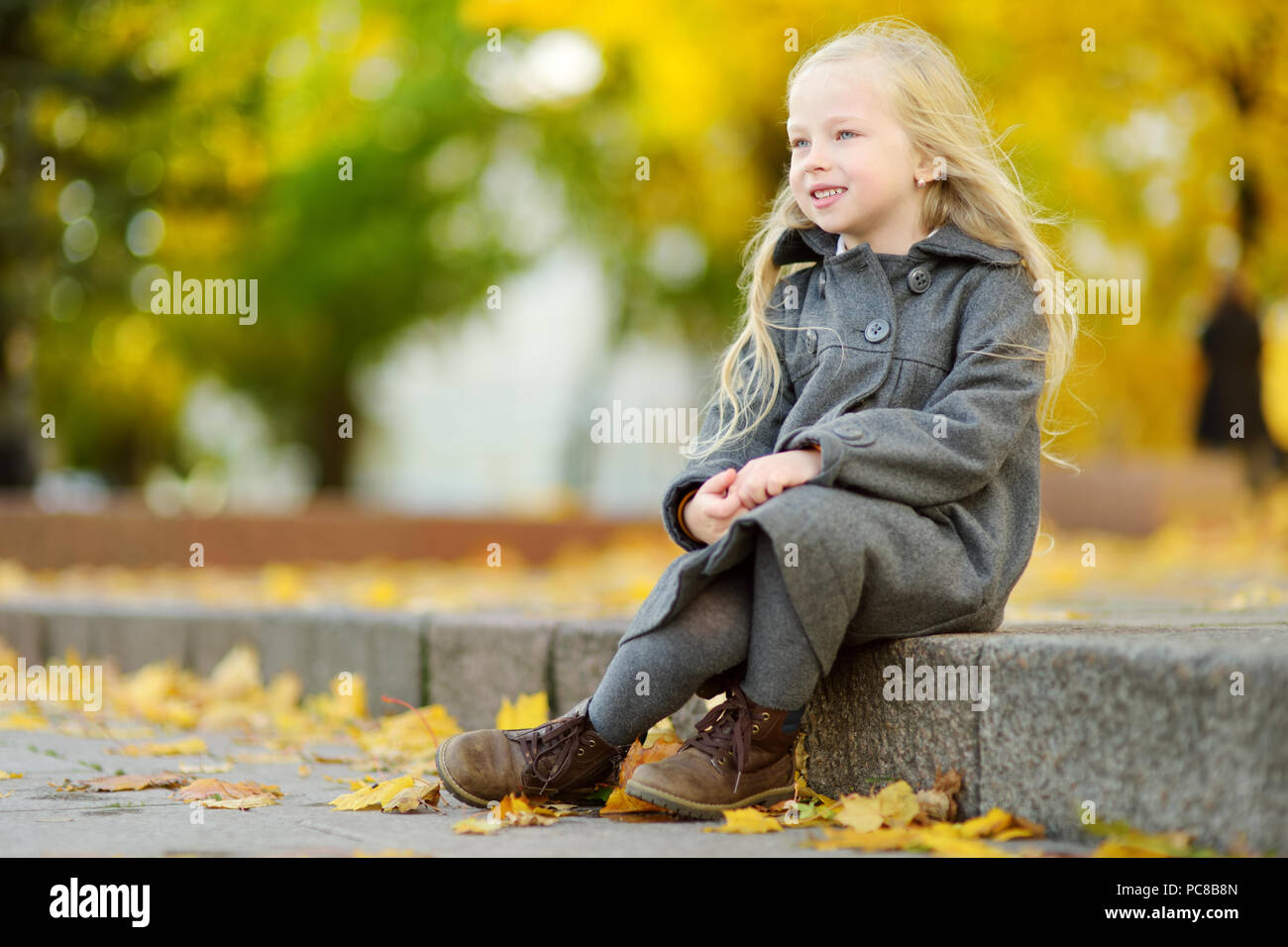Cute little girl having fun on beautiful autumn day. Happy child ...