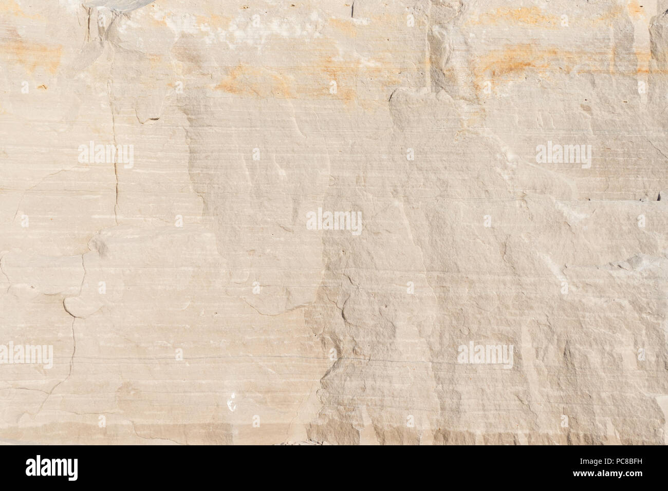 Closeup limestone rock face showing weathered strata for a geological