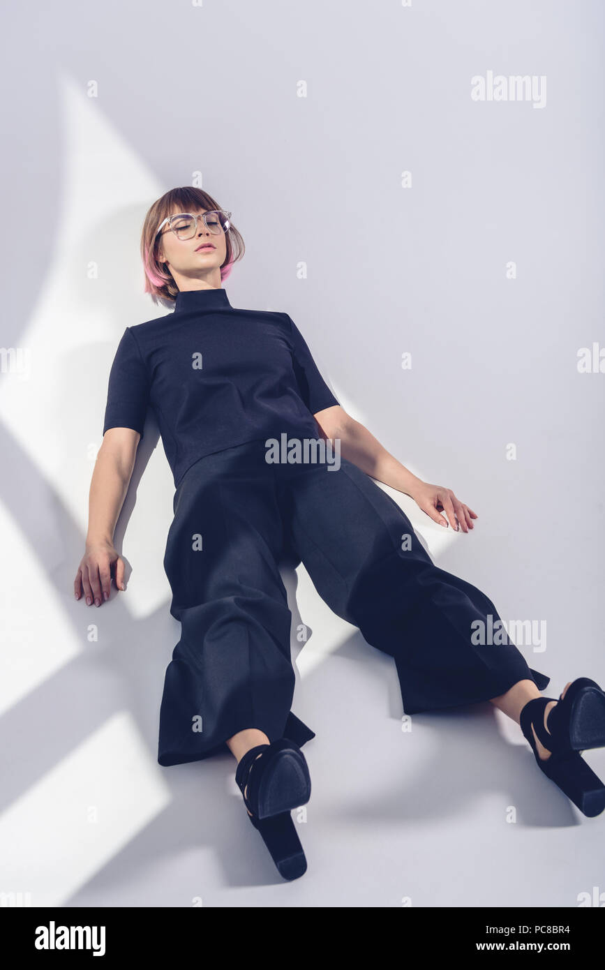 stylish girl lying with closed eyes on white Stock Photo - Alamy