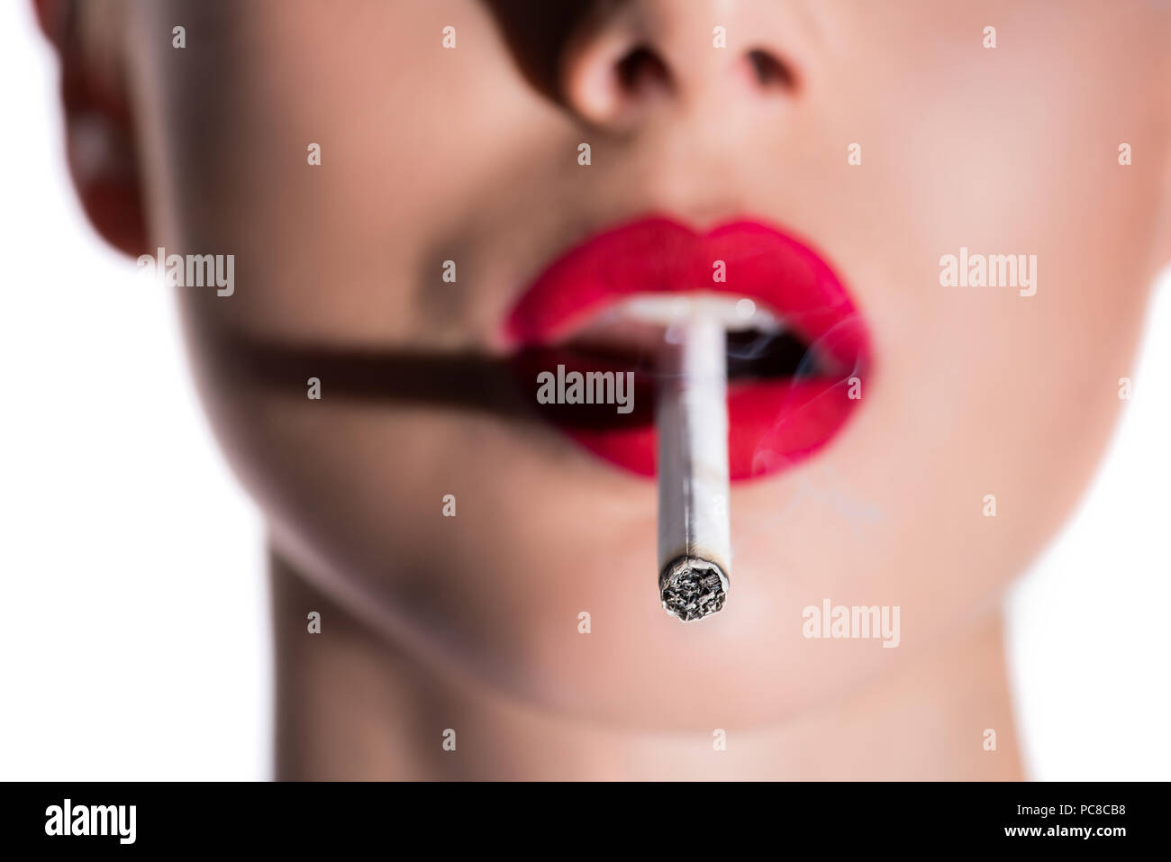Young woman smoking cigarette red lips hires stock photography and