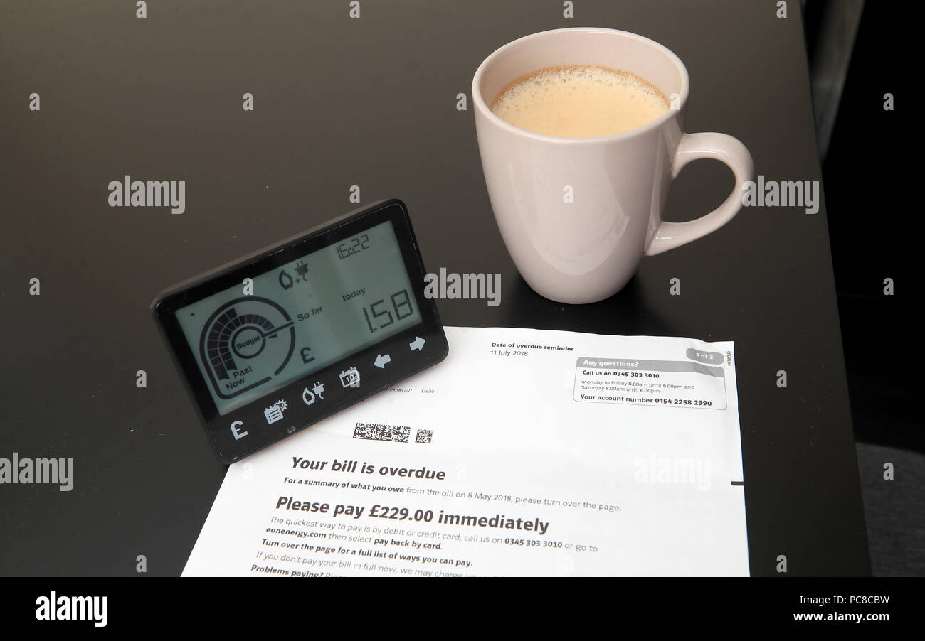 A smart meter next to an energy bill. Stock Photo