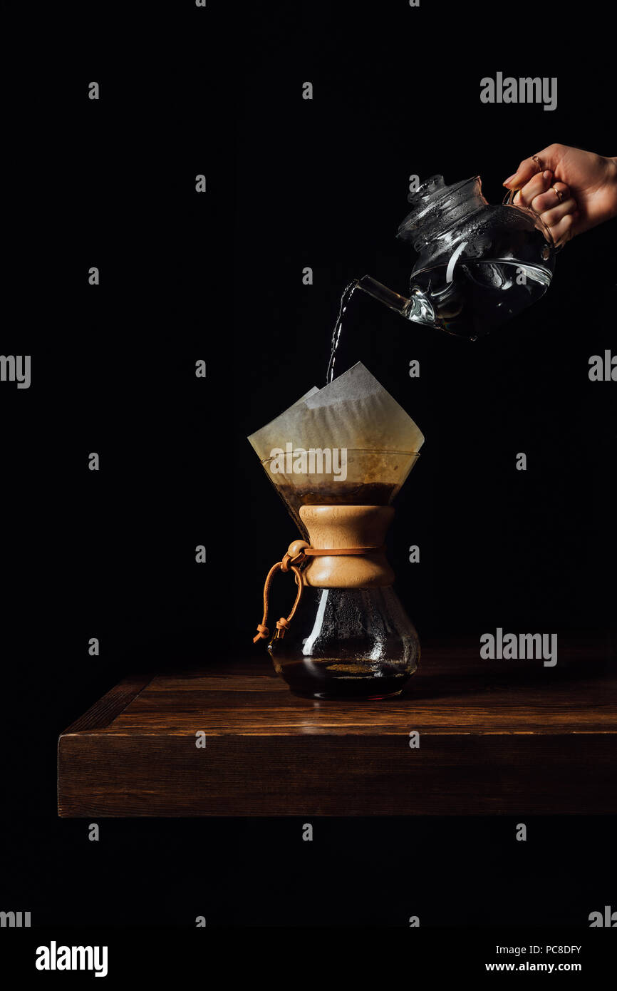 Cropped image of woman pouring hot water in chemex with filter cone Stock Photo