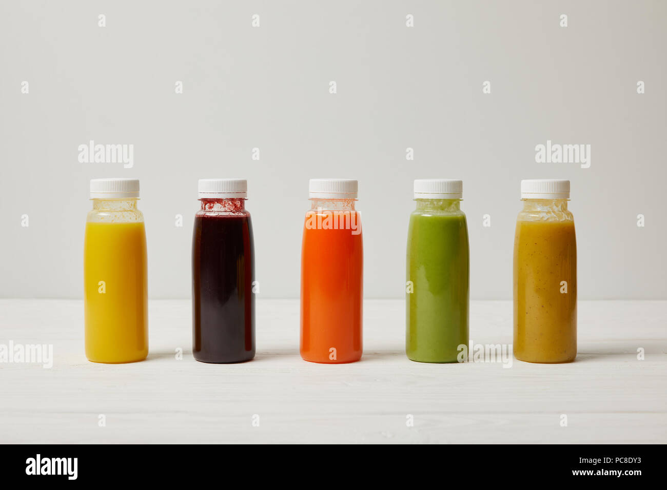 detox smoothies in bottles standing in row, refresh concept Stock Photo