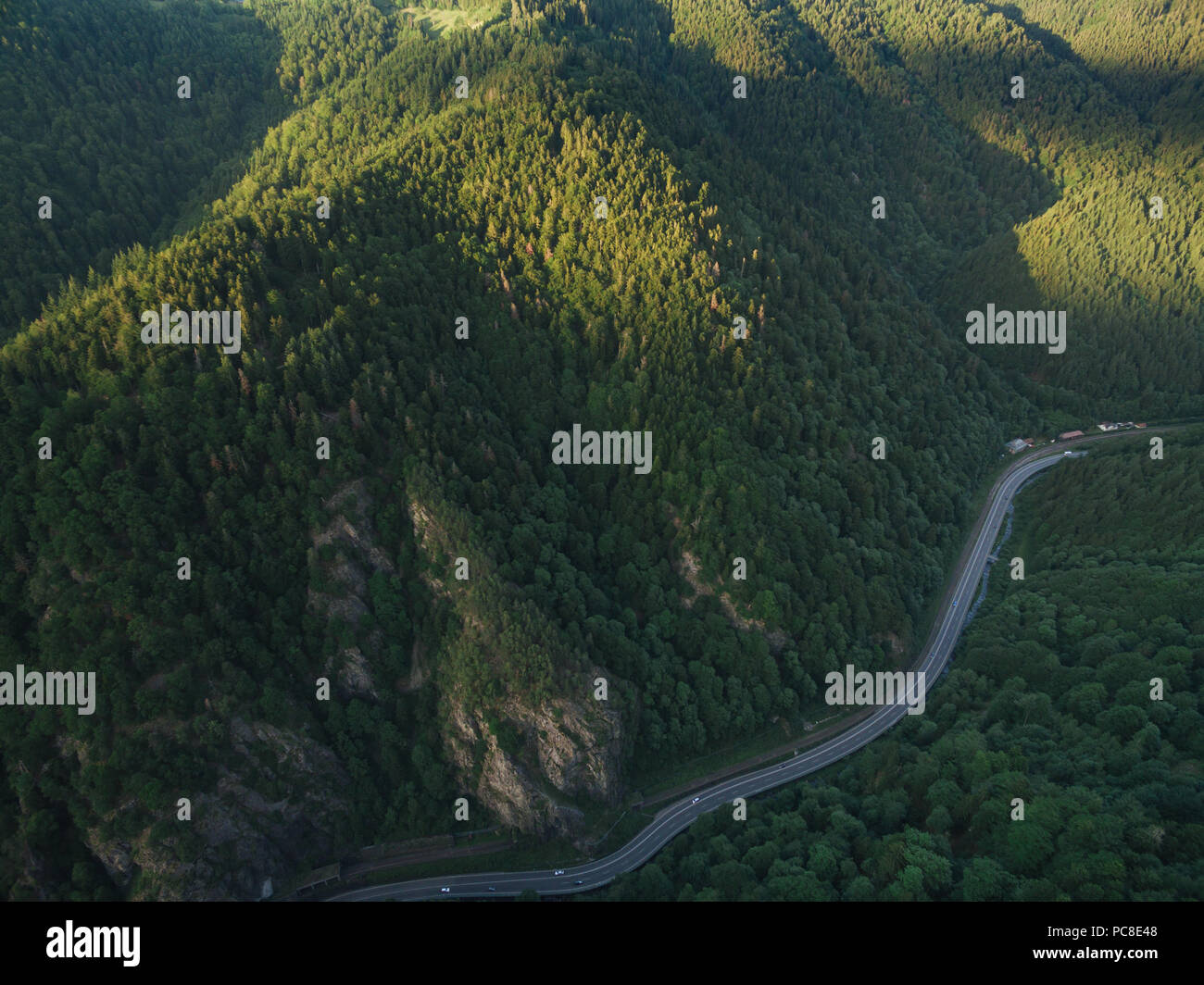 aerial view of road in beautiful mountain forest on sunset Stock Photo ...
