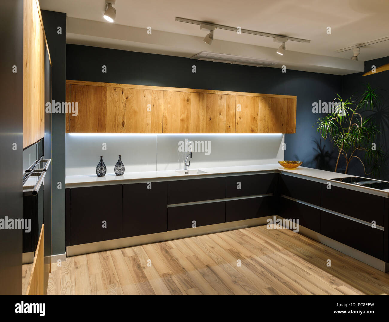Stylish kitchen with modern white counter and sink Stock Photo - Alamy