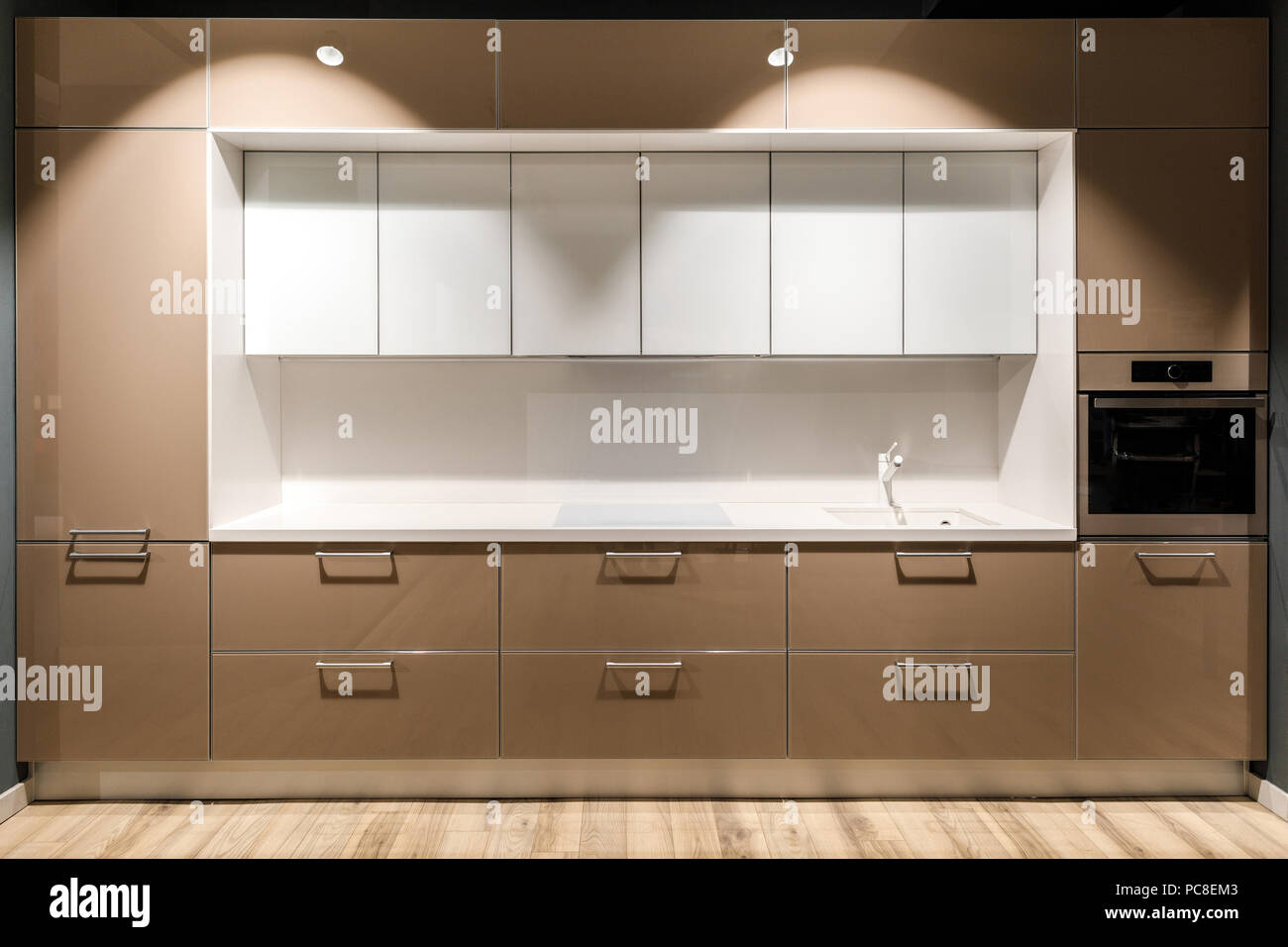 Interior of modern kitchen with stylish design in brown and white ...
