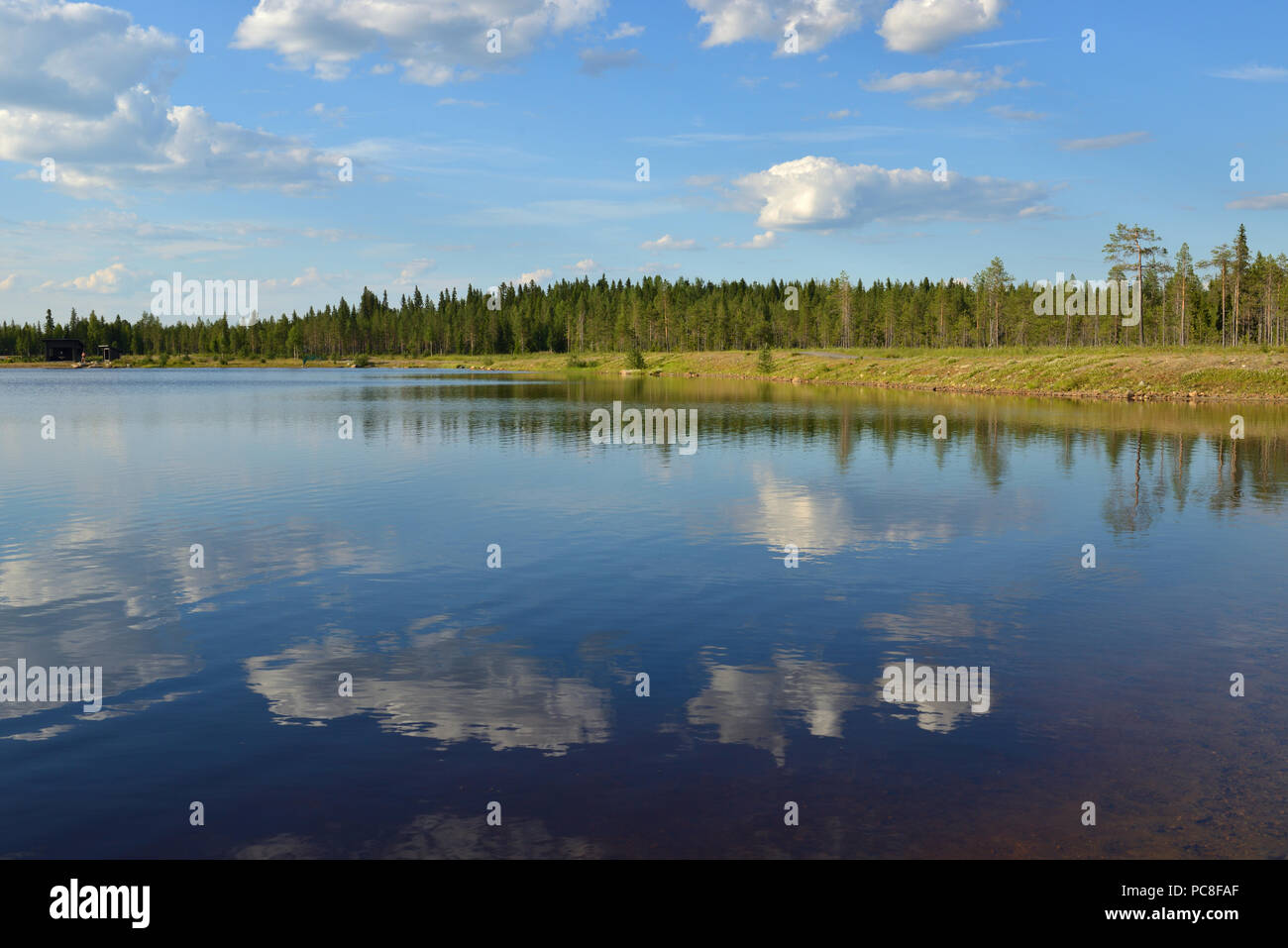 Summer landscape. Picturesque lake with reflection of clouds in Finnish Lapland Stock Photo