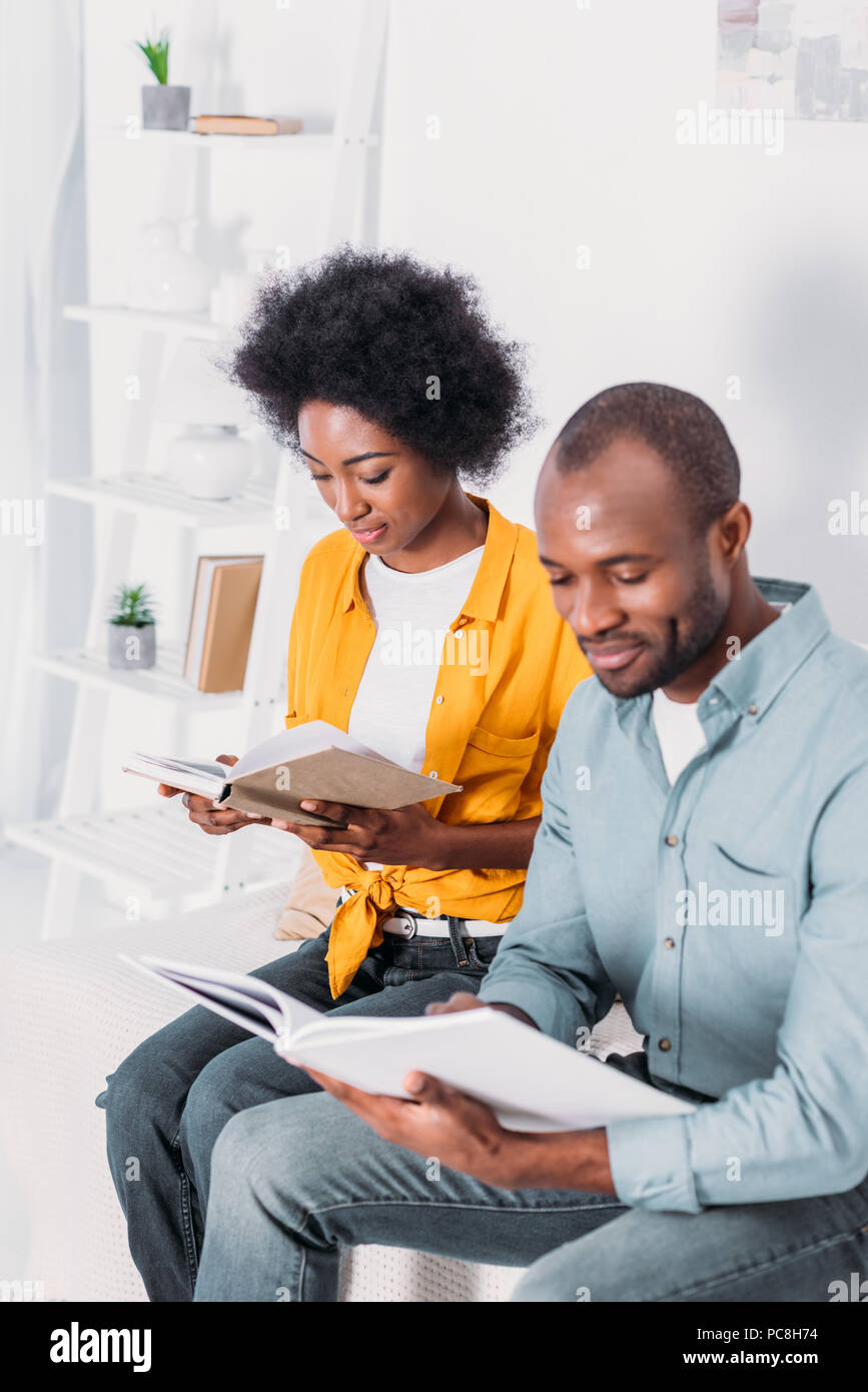 african american couple reading books at home Stock Photo - Alamy