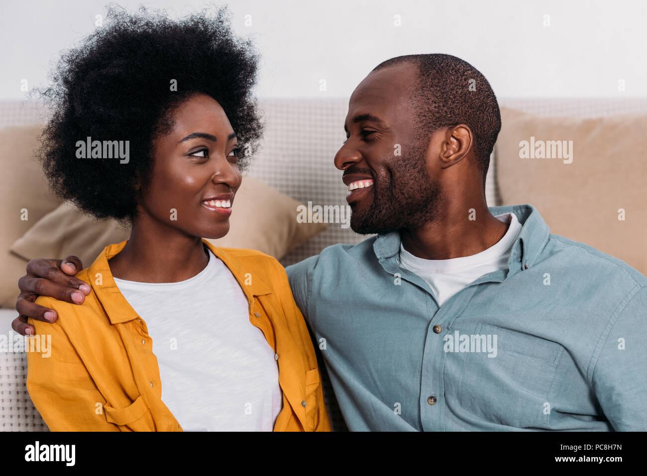 laughing african american couple looking at each other at home Stock ...
