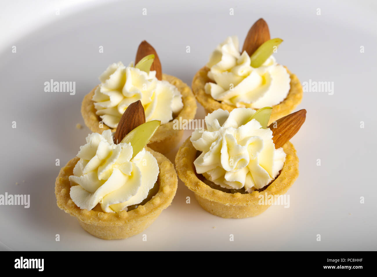 Tartlet with cream, grape and almond for catering Stock Photo Alamy