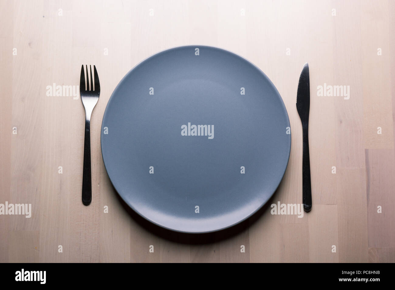 Top view of a restaurant table with plate, knife and fork, restaurant concept Stock Photo
