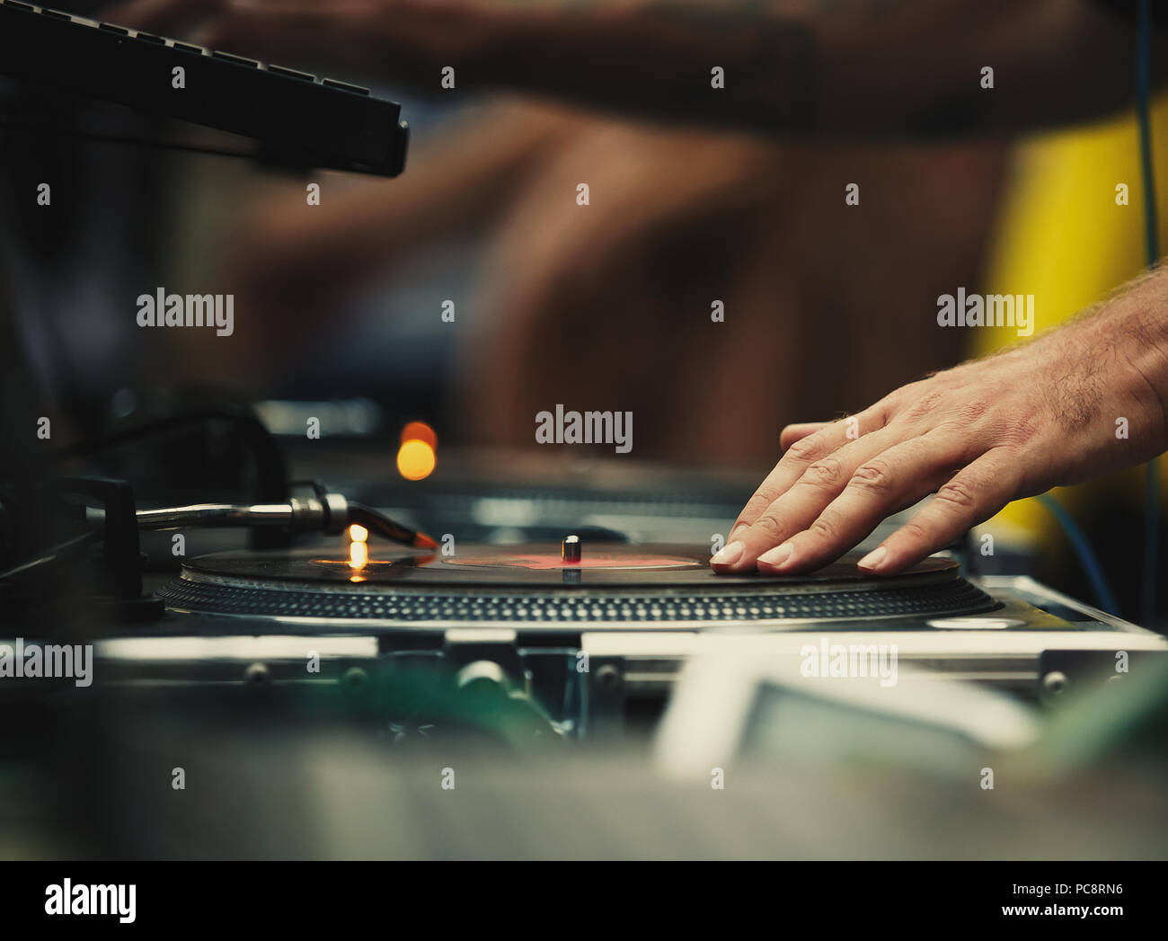 Club dj scratch vinyl records with music on hip hop party in club.Professional disc jockey mix