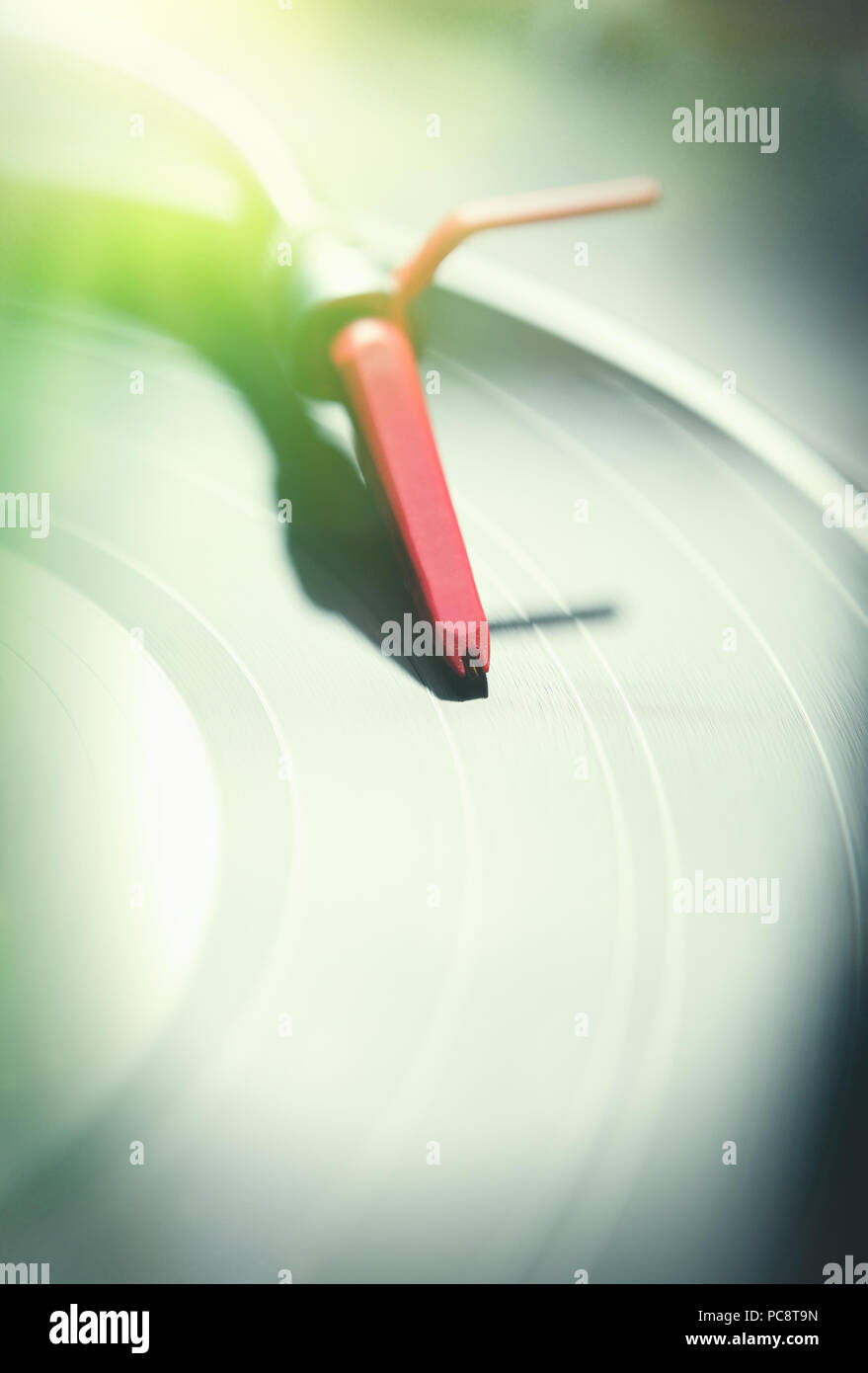 Turntables tone arm with needle on vinyl record with music.Play