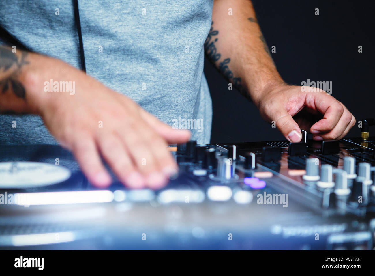Professional disc jockey scratches vinyl records with hip hop music on