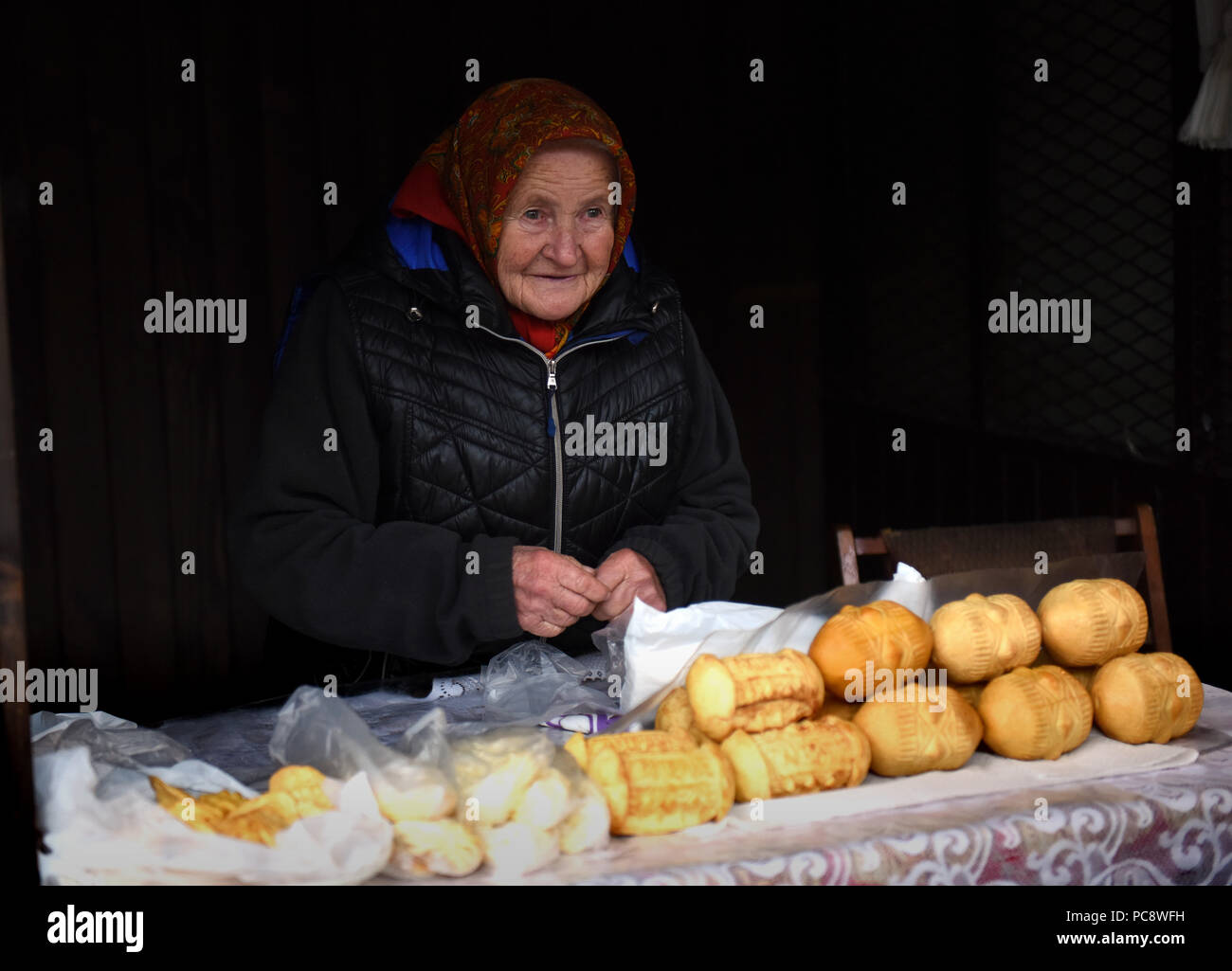 Old lady selling Oscypek and Golka traditional cheese from Polish mountains on sale Zakopane Poland Stock Photo