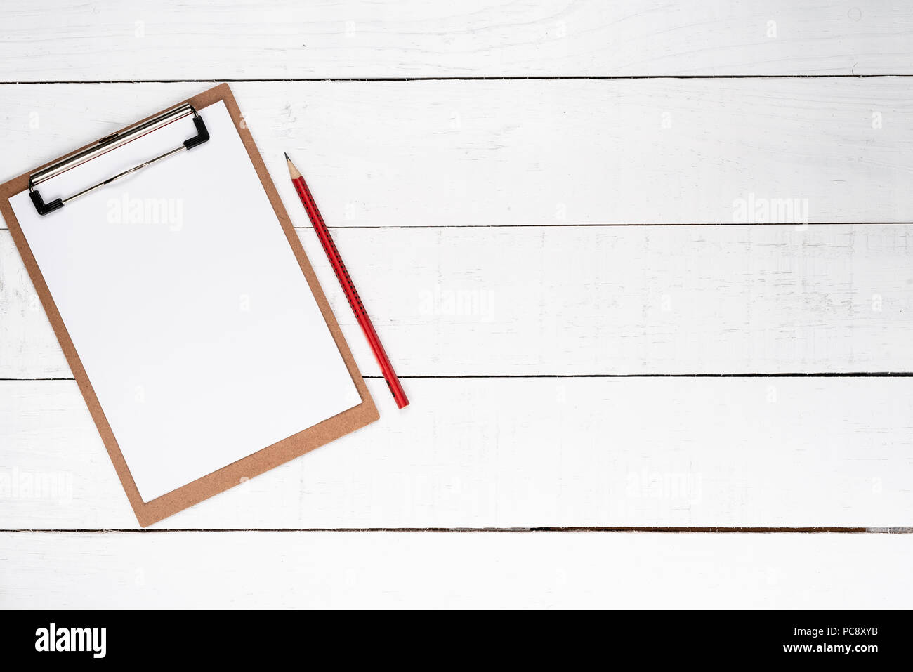 White notepad on red lapis over white wooden background Stock Photo