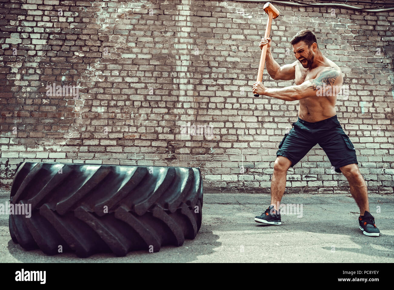 Crossfit sledge hammer man workout hires stock photography and images