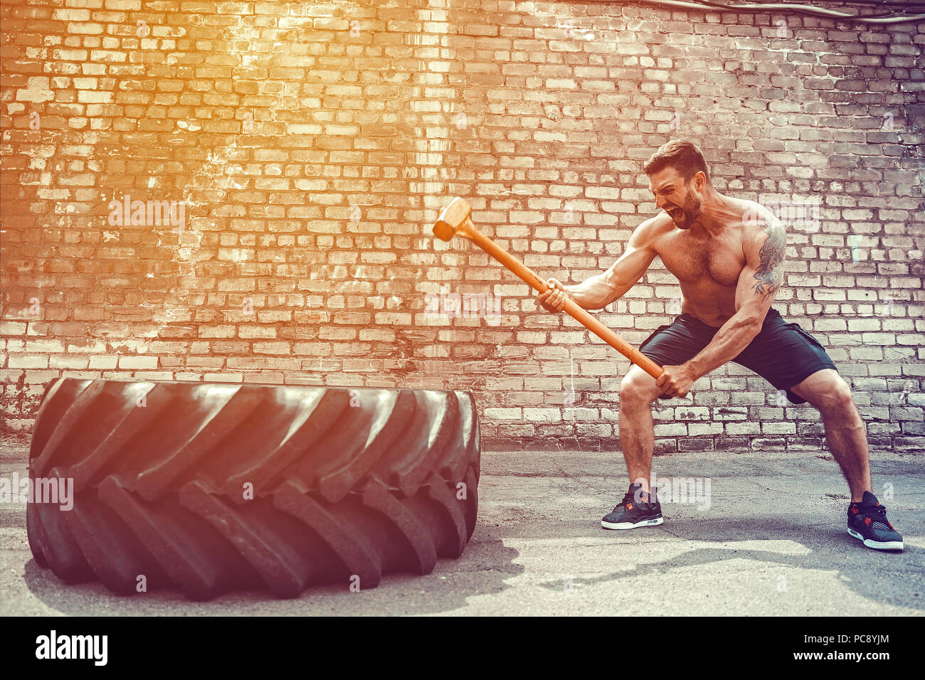 Crossfit sledge hammer man workout hires stock photography and images