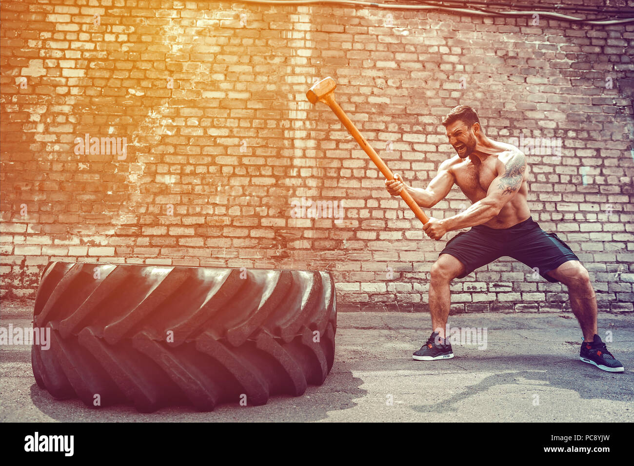 Crossfit sledge hammer man workout hires stock photography and images