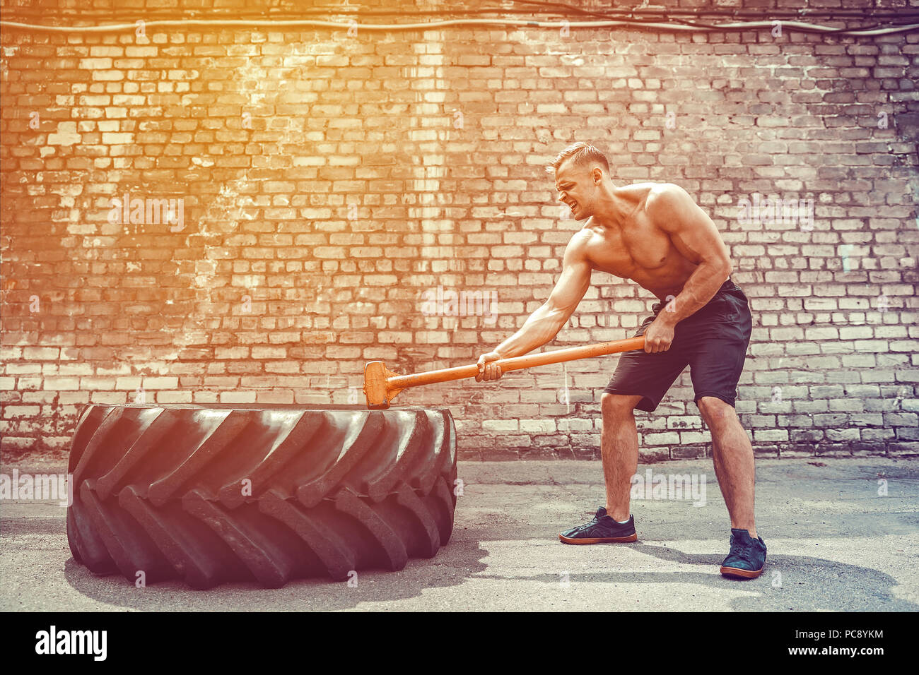 Crossfit sledge hammer man workout hires stock photography and images