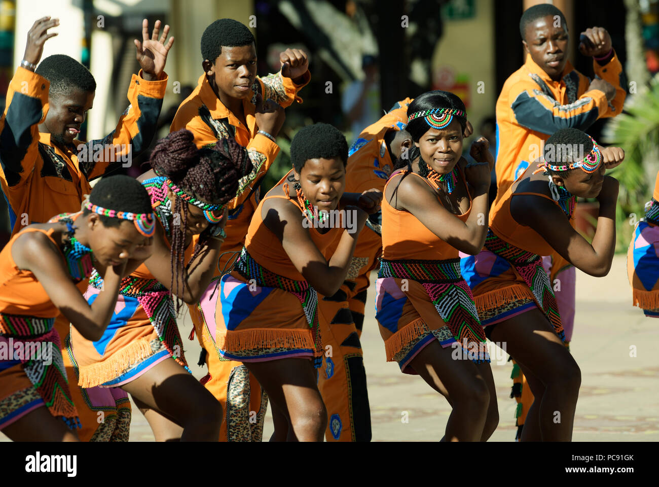 Expressions on the faces of young male and female street performers while performing traditional Zulu folk songs, Durban, South Africa Stock Photo