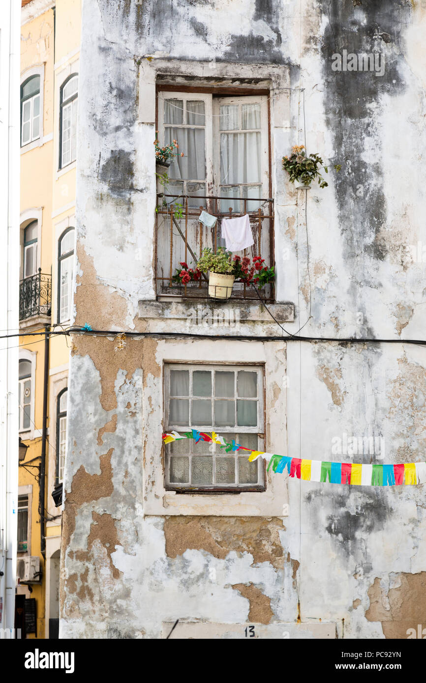 Old stone apartment building facade, with laundry hanging to dry from