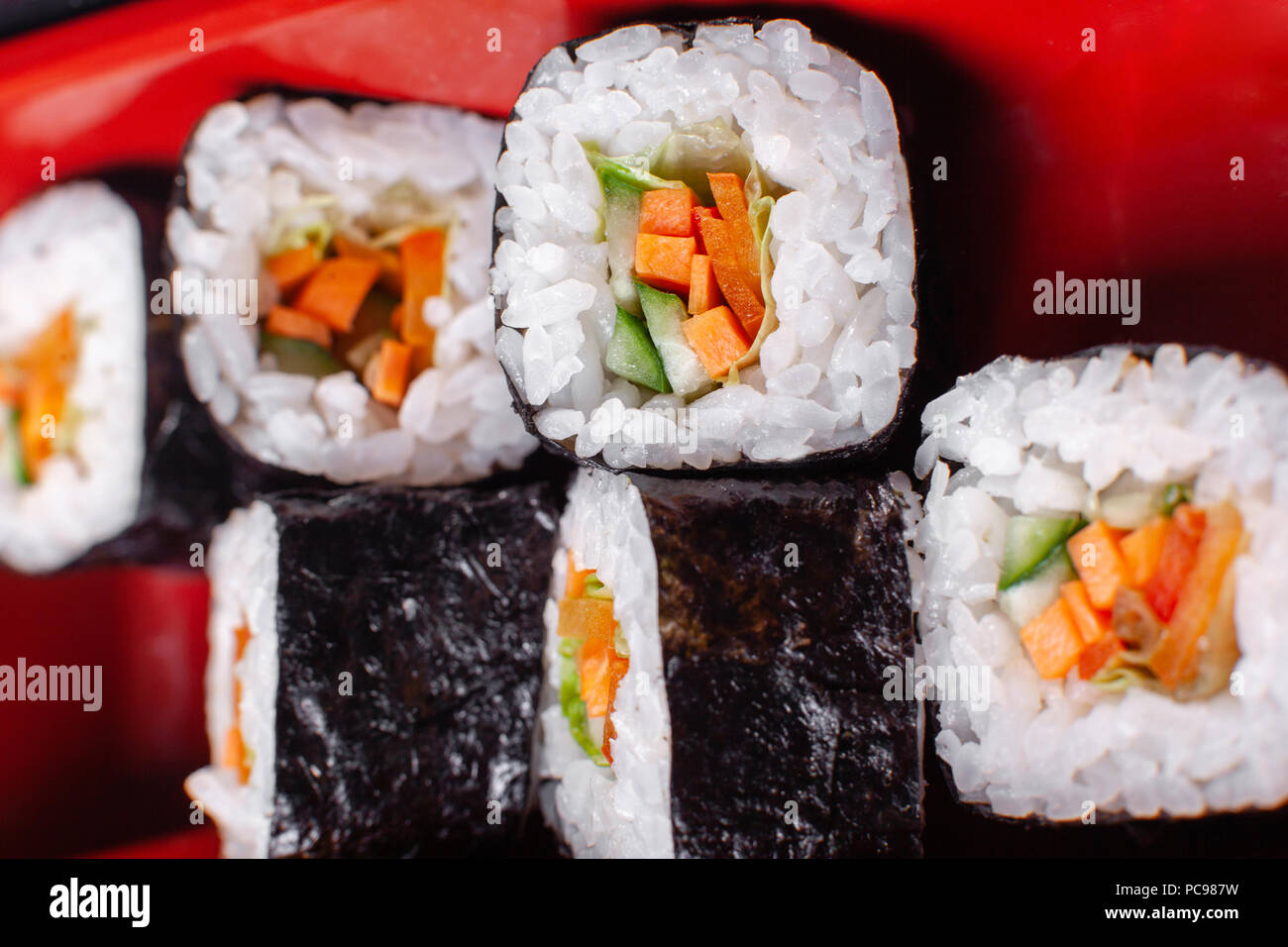 Fresh food portion in japanese bento box with salad, main course. Sushi