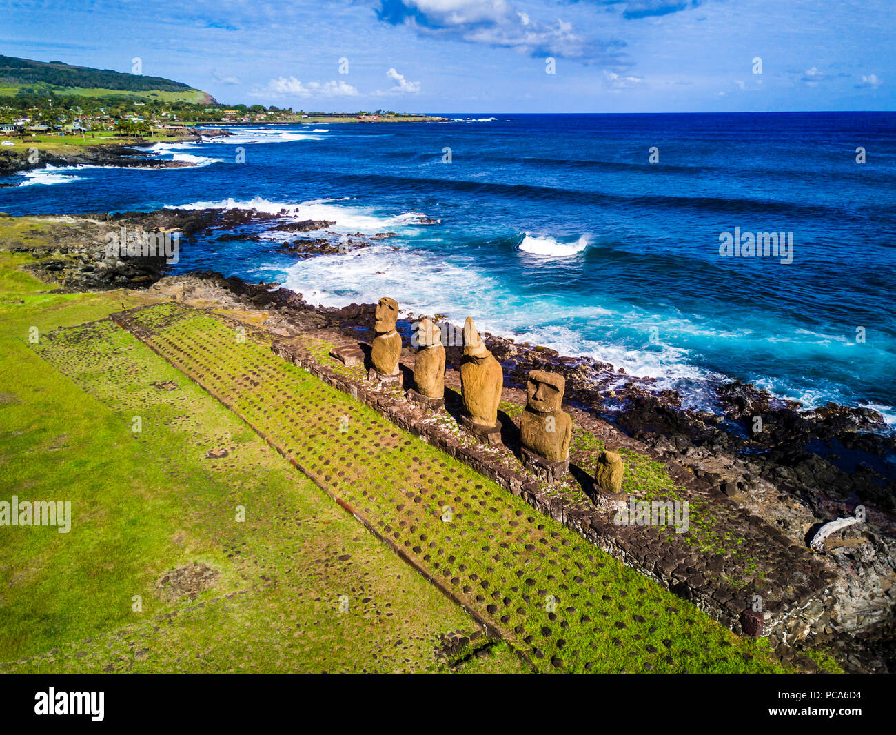 An Aerial View over Ahu Tahai alone Moai at Hanga Roa, Easter Island. This is the only one with painted eyes like it was on the past. Stock Photo