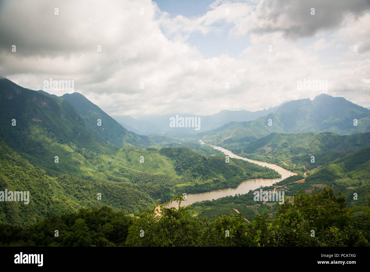 Nam Ou river flowing through beautiful lush green landscape seen from a viewpoint above Nong Khiaw in Laos PDR. Stock Photo