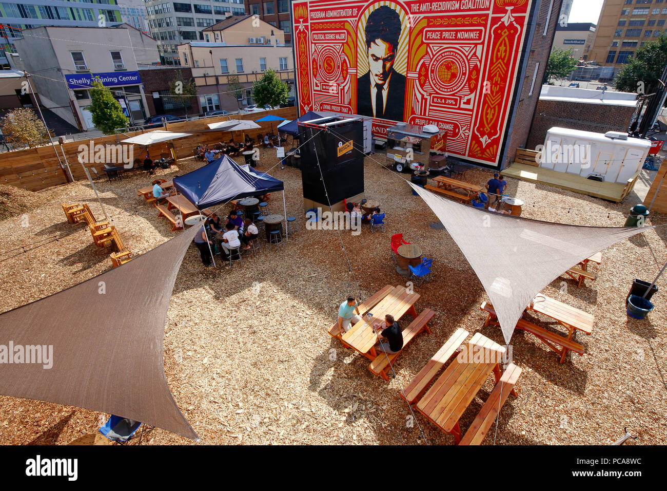 People Relaxing Under Tents Under The Watchful Eye Of A Prison