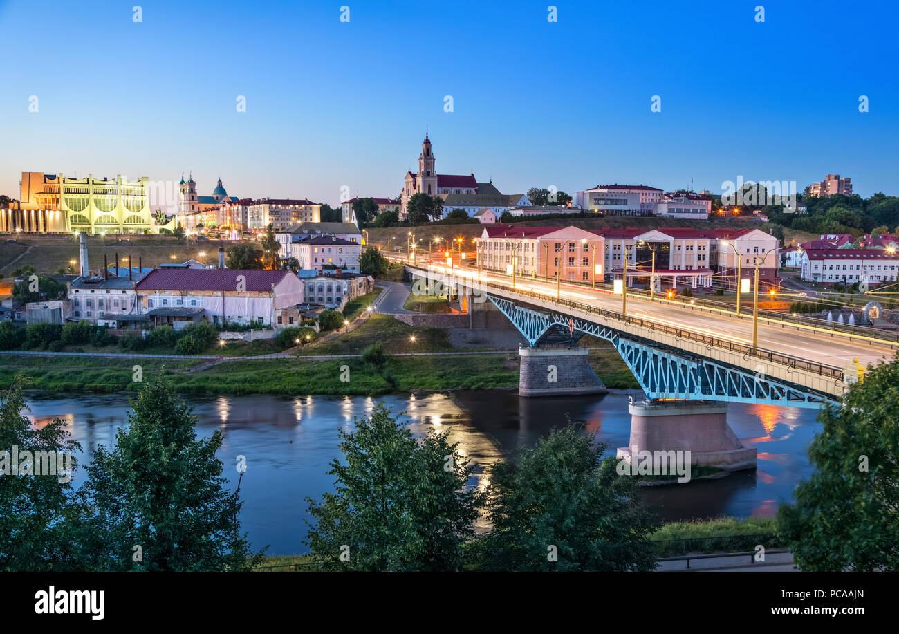 Cityscape of Grodno at dusk with bridge over Neman river, Belarus Stock Photo