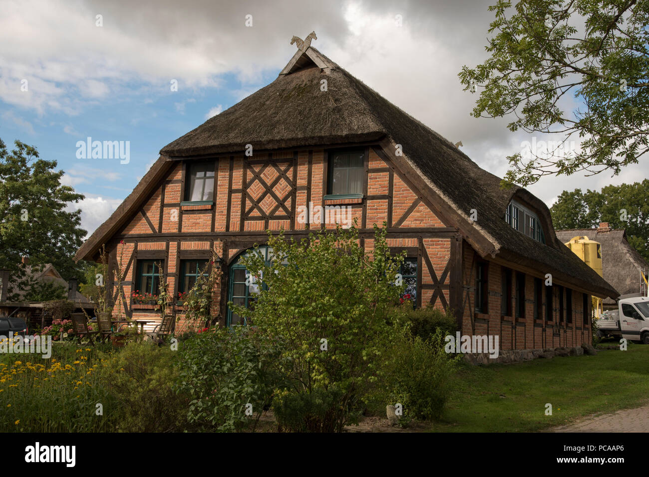 Thatch-roof house in Groß-Stresow in the southeast of Ruegen Island in the Baltic Sea in Northeastern Germany. Stock Photo