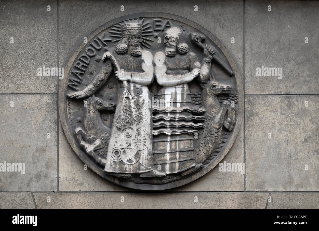 Marduk and Ea. Stone relief at the building of the Faculte de Medicine Paris, France Stock Photo