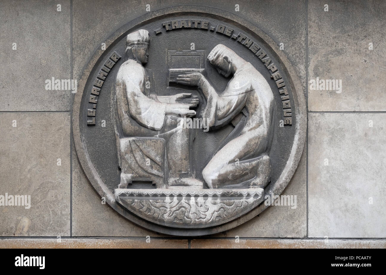 The first therapeutic treatise. Stone relief at the building of the Faculte de Medicine Paris, France Stock Photo